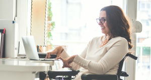 woman in wheelchair typing