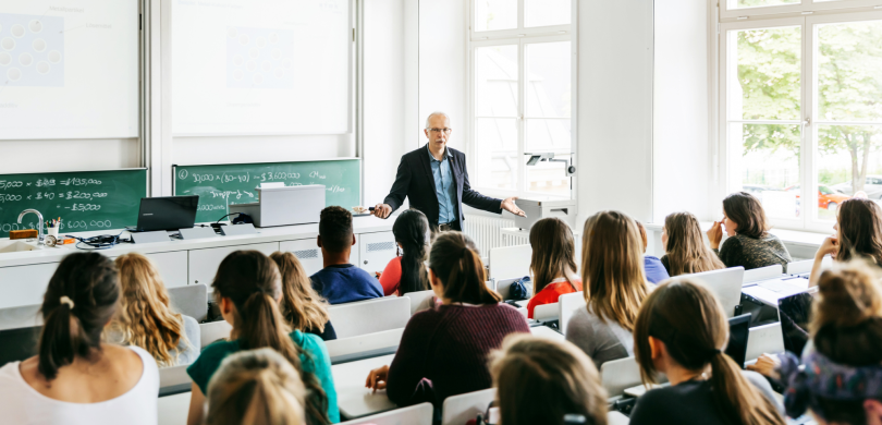 Professor teaching students in a college lecture hall