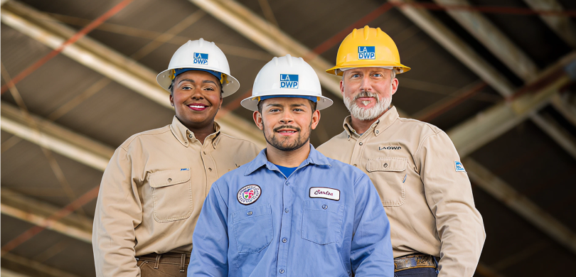 three people wearing los Angeles power and water helmets