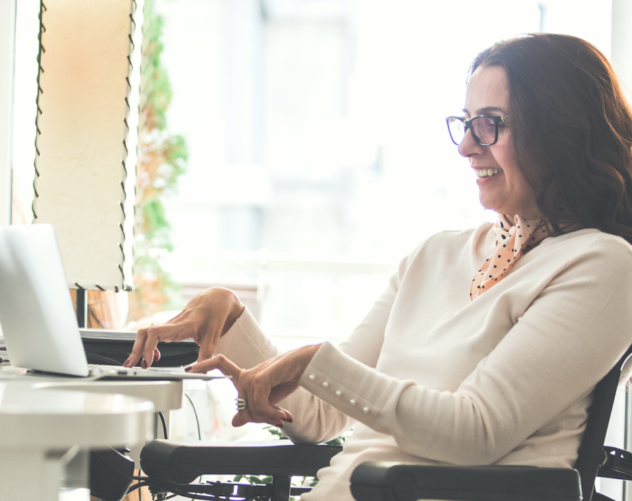 woman in wheelchair typing