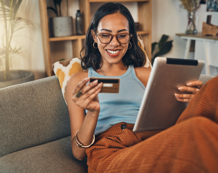 Woman reading credit card information while using a tablet